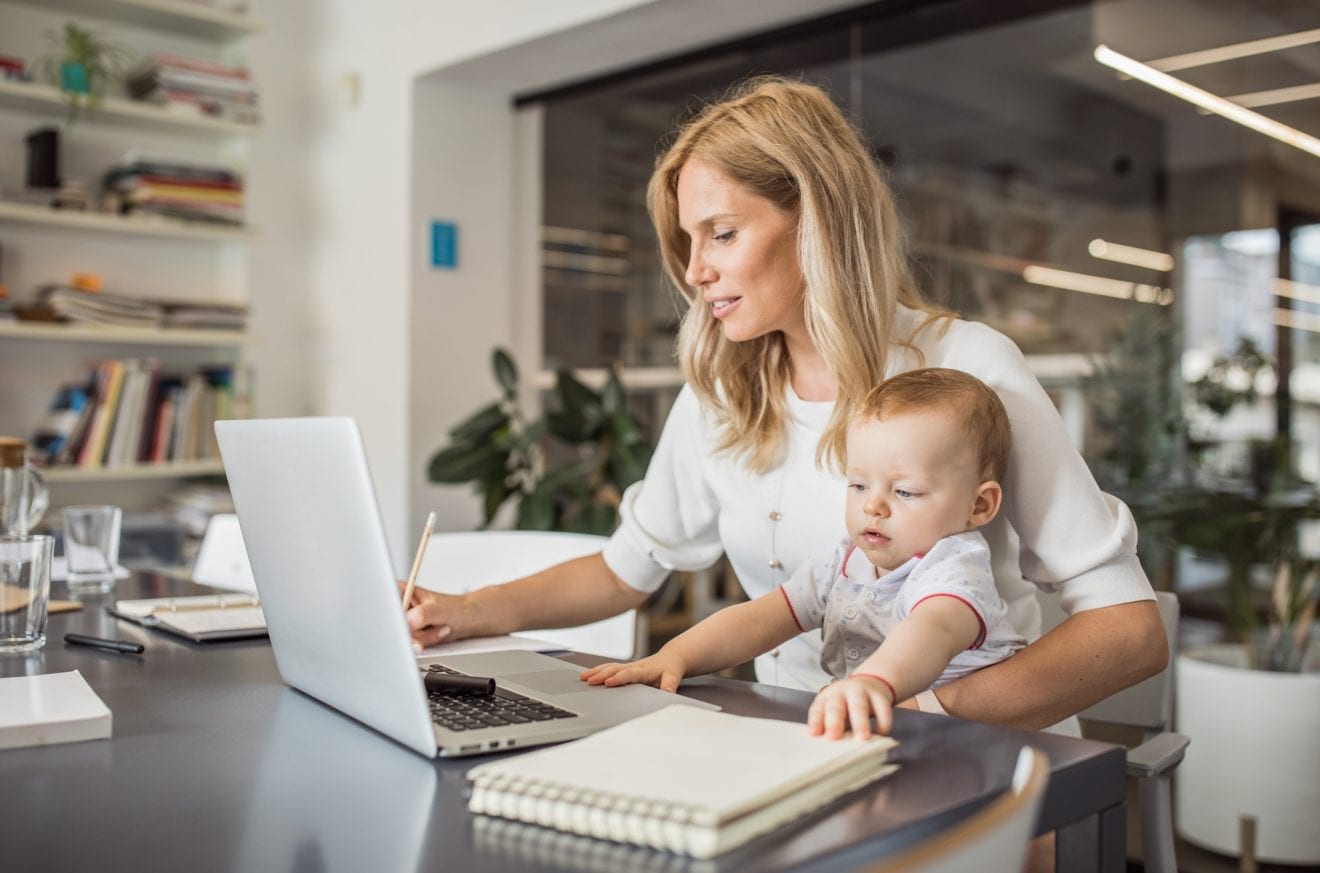 Single-mother-with-baby-working-in-office-1042365540_2131x1410